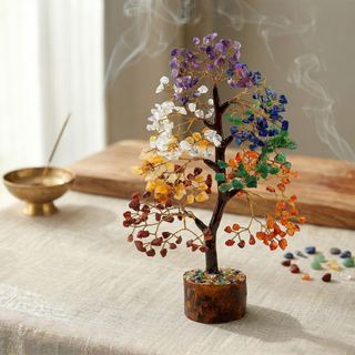 7 Chakra crystal tree with incense smoke and loose gemstone chips beside it