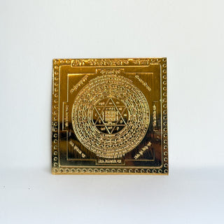 Shri Kuber Yantra gold metal plate for wealth and abundance, engraved with sacred geometric pattern and mantras