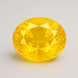 Natural yellow sapphire (Pukhraj) gemstone, faceted oval cut, front angle view
Title: Natural Yellow Sapphire (Pukhraj) Gemstone - Front View